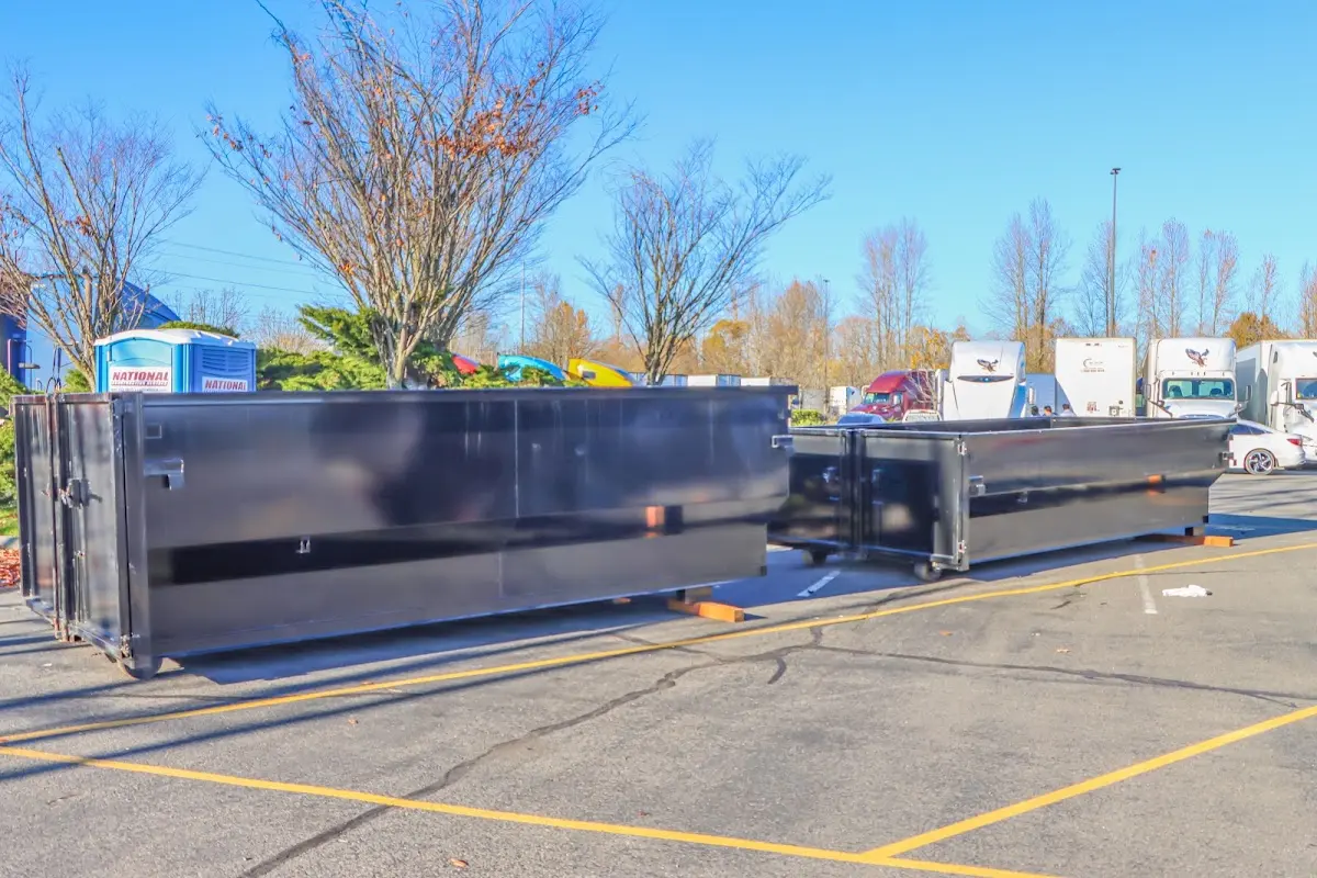 Professional dumpster rental service with roll-off container on residential driveway in Gold Canyon